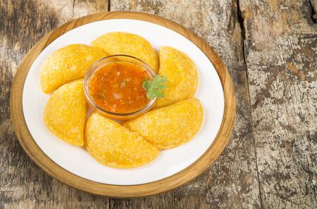 Colombian empanada with spicy sauce