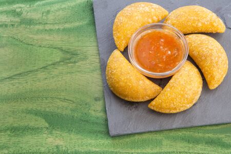 Colombian empanada with spicy sauceの写真素材
