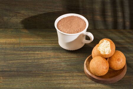Traditional Colombian buÃ±uelo - Deep Fried Cheese Bread. Hot chocolate drink
