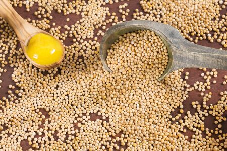 Mustard and seed - Sinapis alba. Wooden backgroundの写真素材