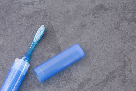 Toothbrush with plastic case - Blue backgroundの写真素材