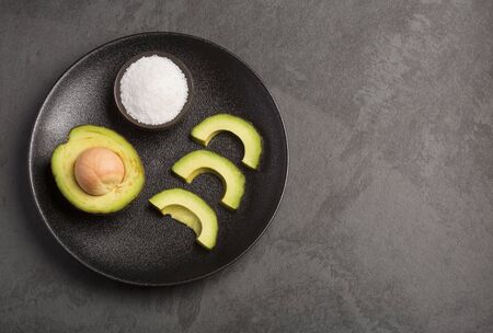 Avocado and salt - Persea americana 'Hass'. Top viewの写真素材
