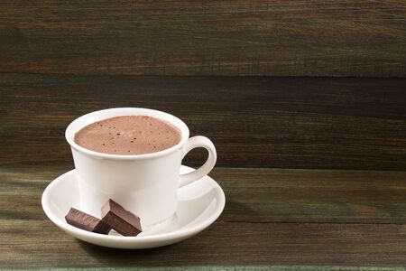 Cup of tasty hot chocolate on wooden backgroundの写真素材