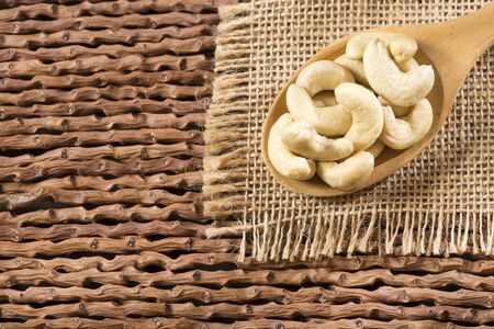Cashew nut on wooden background - Anacardium occidentaleの写真素材
