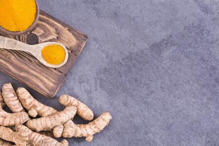 Roots and turmeric powder - Curcuma longa. Space for text