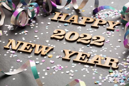 Happy year 2022 - Letters in wood. Black background