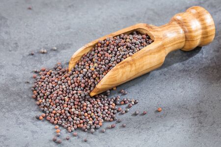 Black mustard seeds - Wooden backgroundの写真素材