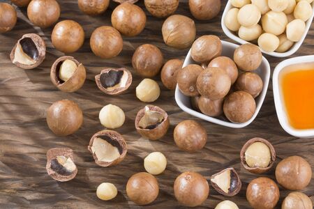 Organic Macadamia nut on wooden table - Macadamia integrifoliaの写真素材