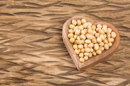 Dry soybeans - Glycine max. Wooden backgroundの写真素材