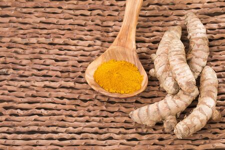 Turmeric powder and fresh turmeric. Top view
