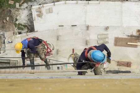 Working at height equipment. Fall arrestor device for worker with hooks for safety body harness