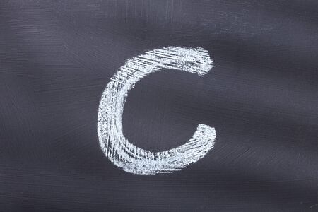 Letter C of the alphabet written with chalkの写真素材