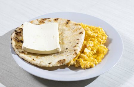 Breakfast arepa, cheese and scrambled egg, traditional Colombian dishの写真素材