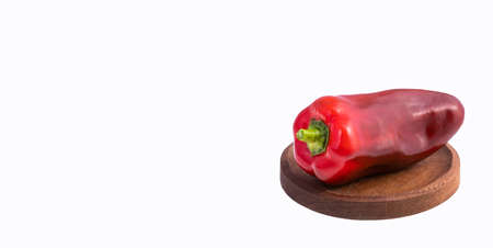 Organic fresh bell pepper on wooden plate - Capsicum annuum