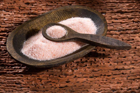 Fine grains of pink Himalayan salt, powder red rock salt from Pakistanの写真素材