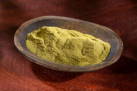 Organic green powder in the wooden bowlの写真素材