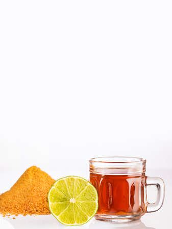 Lime and panela drink - Aguapanela. Saccharum officinarumの写真素材