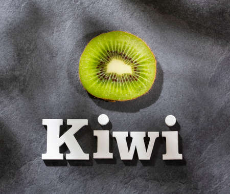 Kiwi slice and phrase kiwi in white lettersの写真素材