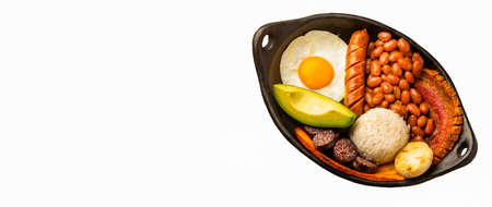 Bandeja paisa, typical dish at the AntioqueÃ±a region of Colombia. It consists of chicharrÃ³n (fried pork belly), black pudding, sausage, arepa, beans, fried plantain, avocado egg, and riceの写真素材