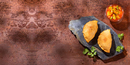 Traditional baked Argentinian empanadas savory pastries with meat beef stuffing