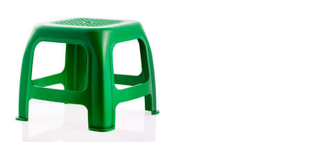 Green plastic chair isolated on white background.