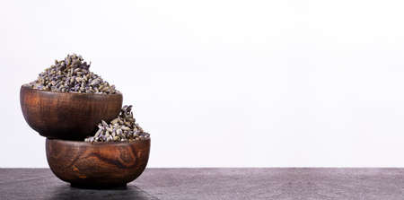 Dried lavender flowers in two wooden bowls - Lavandula.