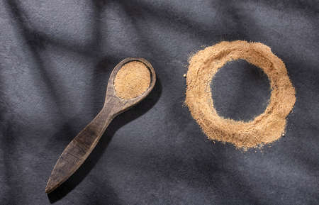 Organic Lepidium meyenii powder on wooden spoon - Maca