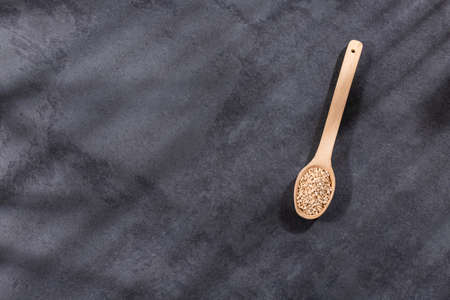 Organic quinoa seeds in wooden spoon - Chenopodium quinoa