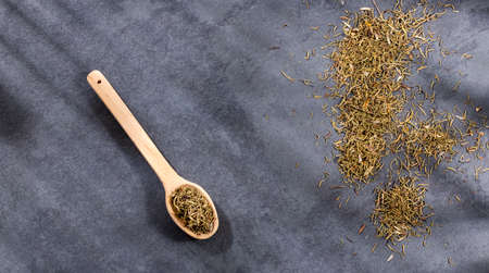 Thymus - Raw dry thyme herb on wooden spoon