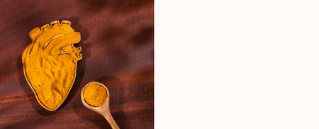 Organic turmeric powder in the heart shaped bowl