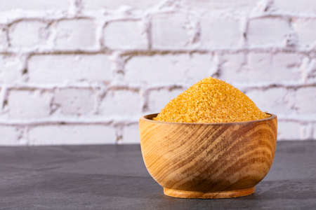 Saccharum officinarum - Organic brown sugar in the wooden bowlの写真素材