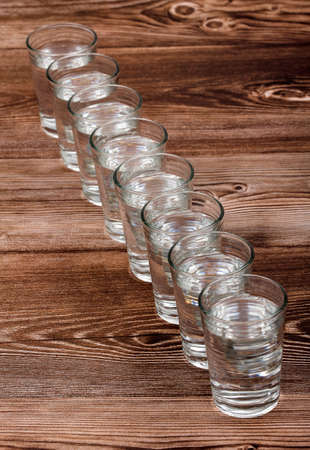 Eight tall glasses of water - Essential water for the proper functioning of our bodyの写真素材