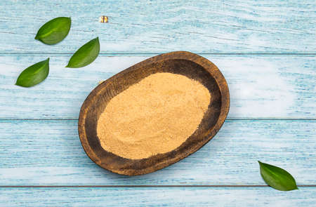 Lepidium meyenii - Maca powder in the wooden bowl