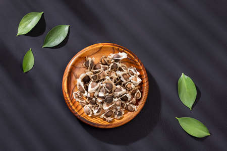 Moringa oleifera - Organic moringa seeds in the wooden bowlの写真素材