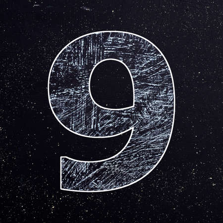 Number 9 written with chalk on the blackboardの写真素材