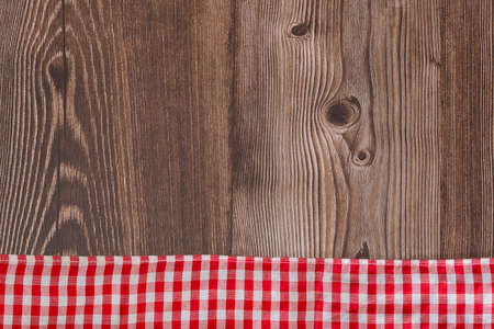 Checkered napkin on rustic wooden background, with space for textの写真素材