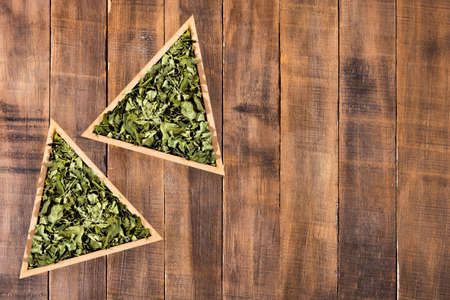 Dried moringa leaves in a triangular bowl - Moringa oleifera