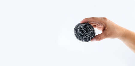 Hand holds metal kitchen sponge - White backgroundの写真素材