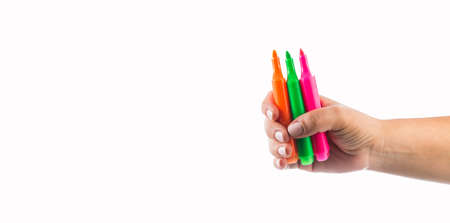 Hand holding colored highlighters - White background