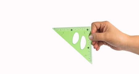 Hand holding transparent triangle ruler - Text spaceの写真素材
