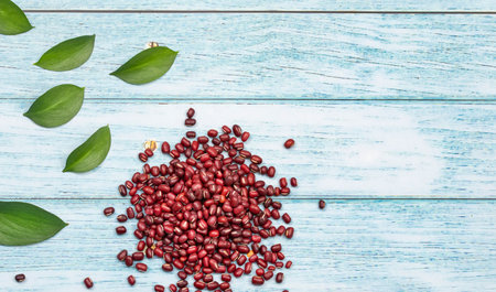 Raw red adzuki beans on wooden background - Vigna angularisの写真素材