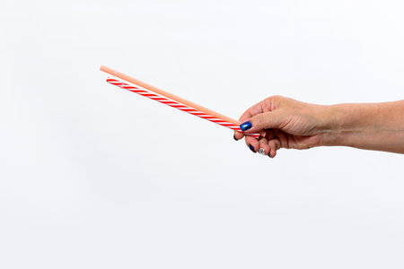 Hand holding reusable straws - Latina woman