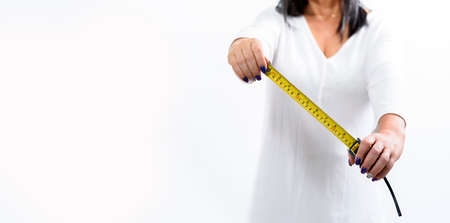 Hands holding tape measure - Latin womanの写真素材