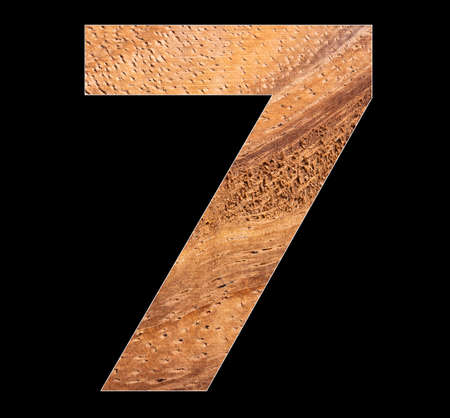 Digit 7 - Number in rustic wood on black backgroundの写真素材