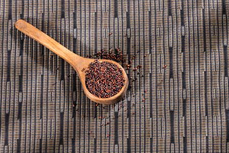 Brown mustard seeds in the spoon - healthy foodの写真素材