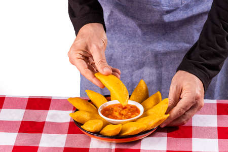 Delicious and traditional Colombian empanadas with spicy sauceの写真素材