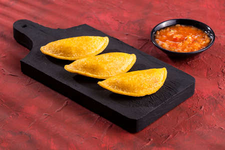 Delicious and traditional Colombian empanadas with spicy sauceの写真素材