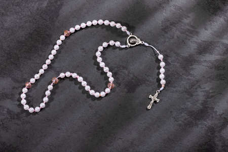 Catholic rosary and crucifix on dark backgroundの写真素材