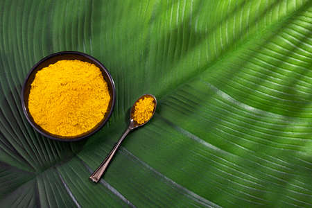 Organic curry yellow powder in the bowl - Healthy foodの写真素材