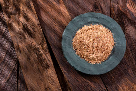 Linum usitatissimum - Crushed flax seeds in the bowlの写真素材